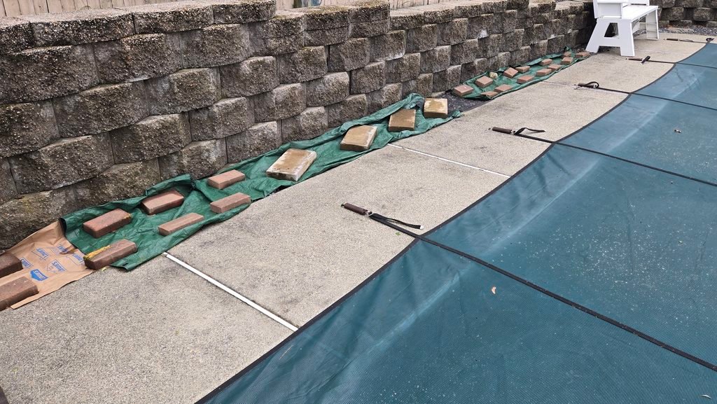 Your Summer to Fall Home Transition. Cover over rock mulch secured with pavers and bricks.